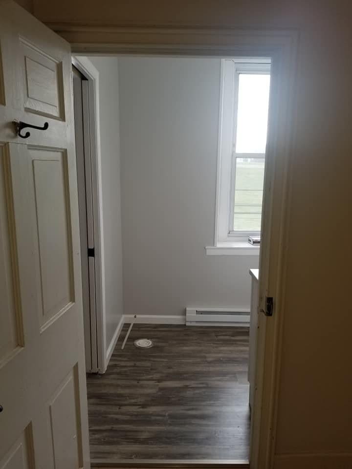 New door casing and baseboard in a hallway